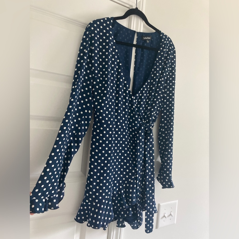 Ruffle trimmed wrap romper with long sleeves. Very flattering and comfortable!